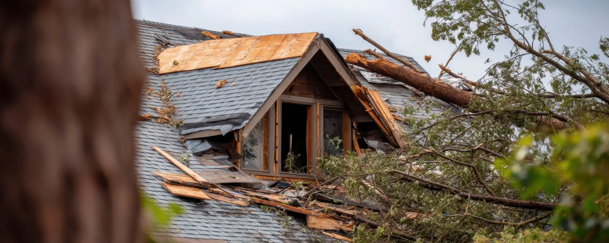 Damaged residential house roof after severe hurricane storm