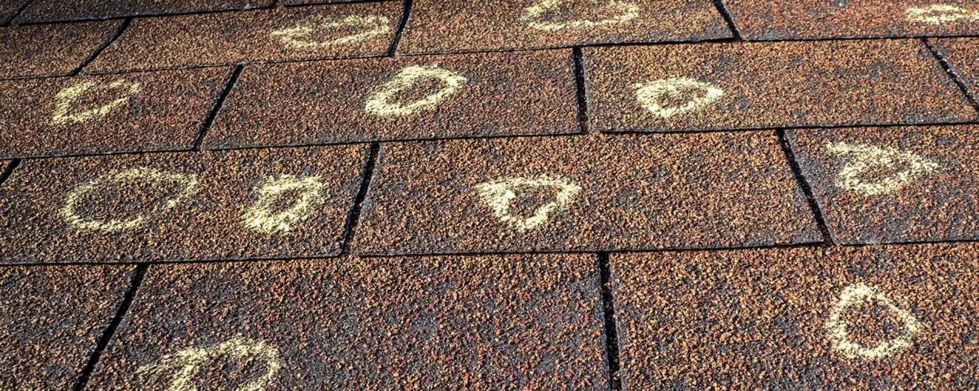 Insurance adjuster marked the hail damage on a insureds roof.